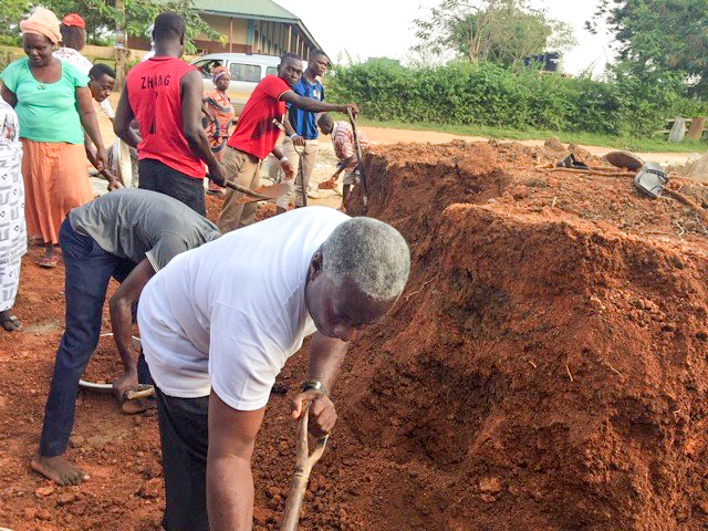 Msgr Simon working with parishioners